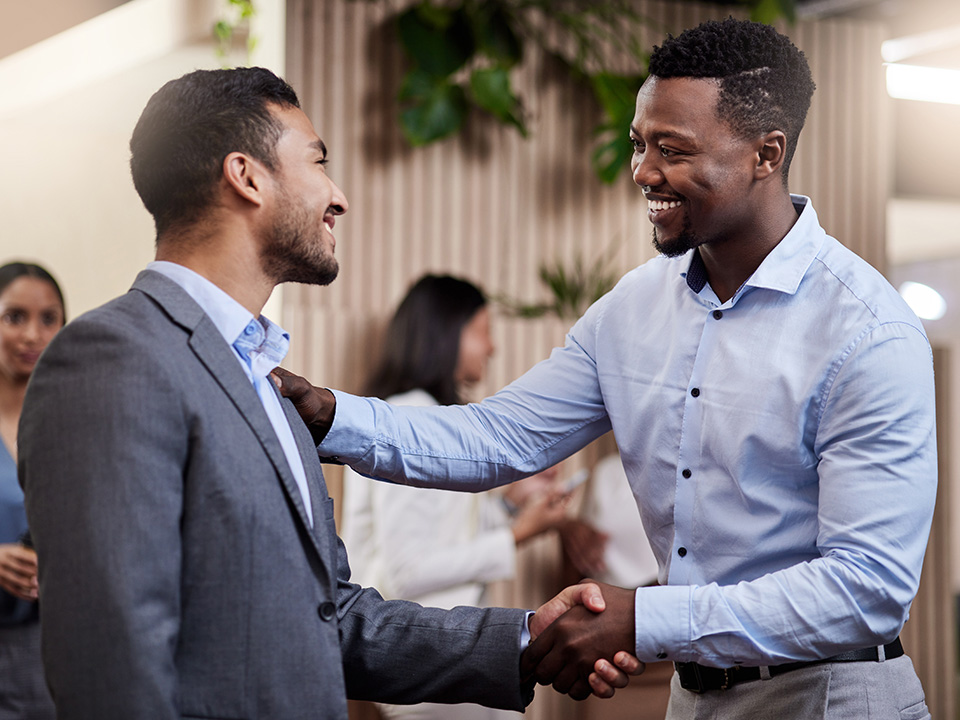 Two business professionals shake hands