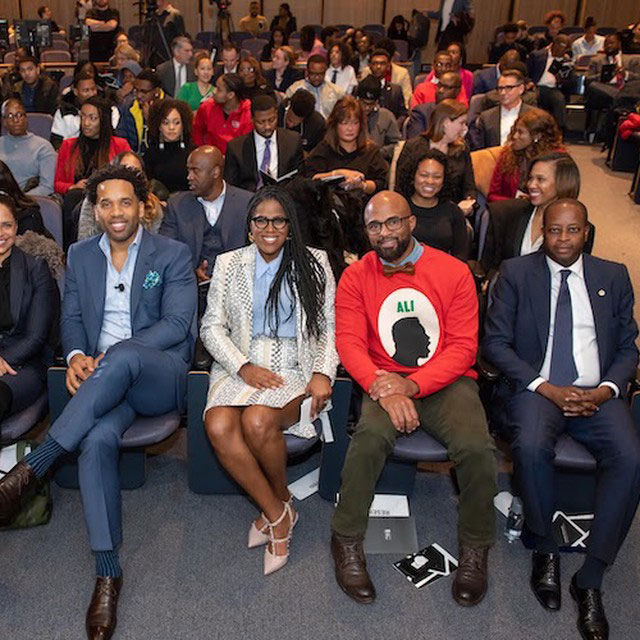 A diverse group sits in the audience at Howard University