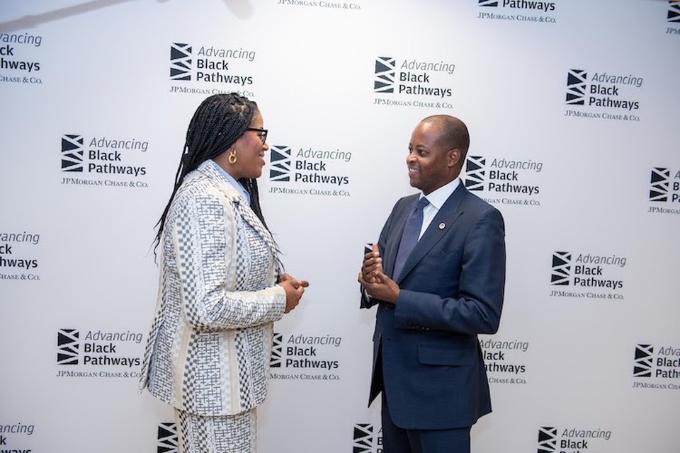 Two professionals stand together at a Howard University networking event